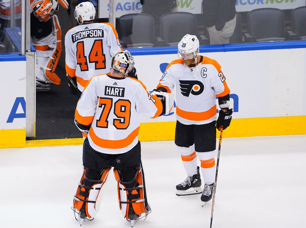 Carter Hart celebrates with captain Claude Giroux