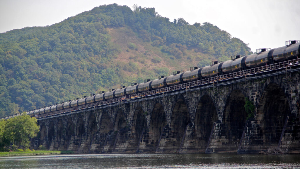IMG_2509 A tanker train crosses the Susquehanna River in Pennsylvania. A proposed new rule that would allow liquefied natural gas to be transported by rail is being challenged because safety and risk assessments have not been done. (Emma Lee/WHYY)