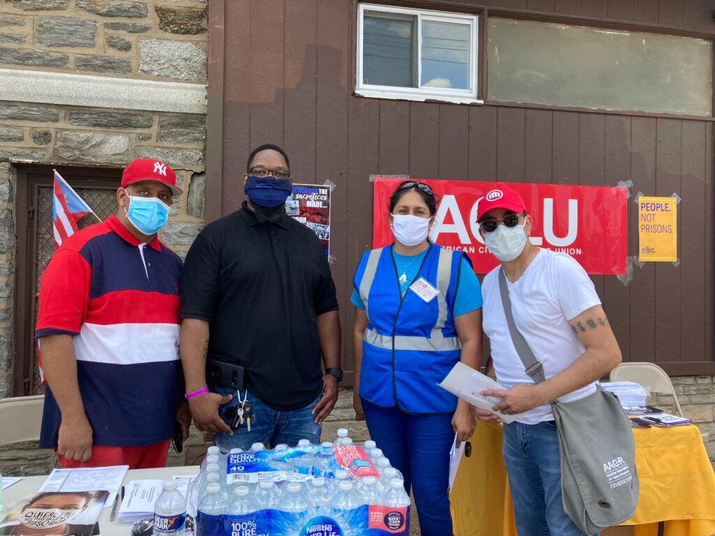 Image from iOS (123) Organizers from several groups outside a church in North Philadelphia for a voter outreach event targeting Puerto Rican residents, immigrants, and formerly incarcerated individuals to give them information on voting rights. (Zachariah Hughes/WHYY)