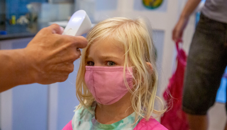 Hannah Morris has her temperature taken before entering Tender Years Child Development Center in Mechanicsburg, Pa., Aug. 4, 2020. (Mark Pynes / PennLive)