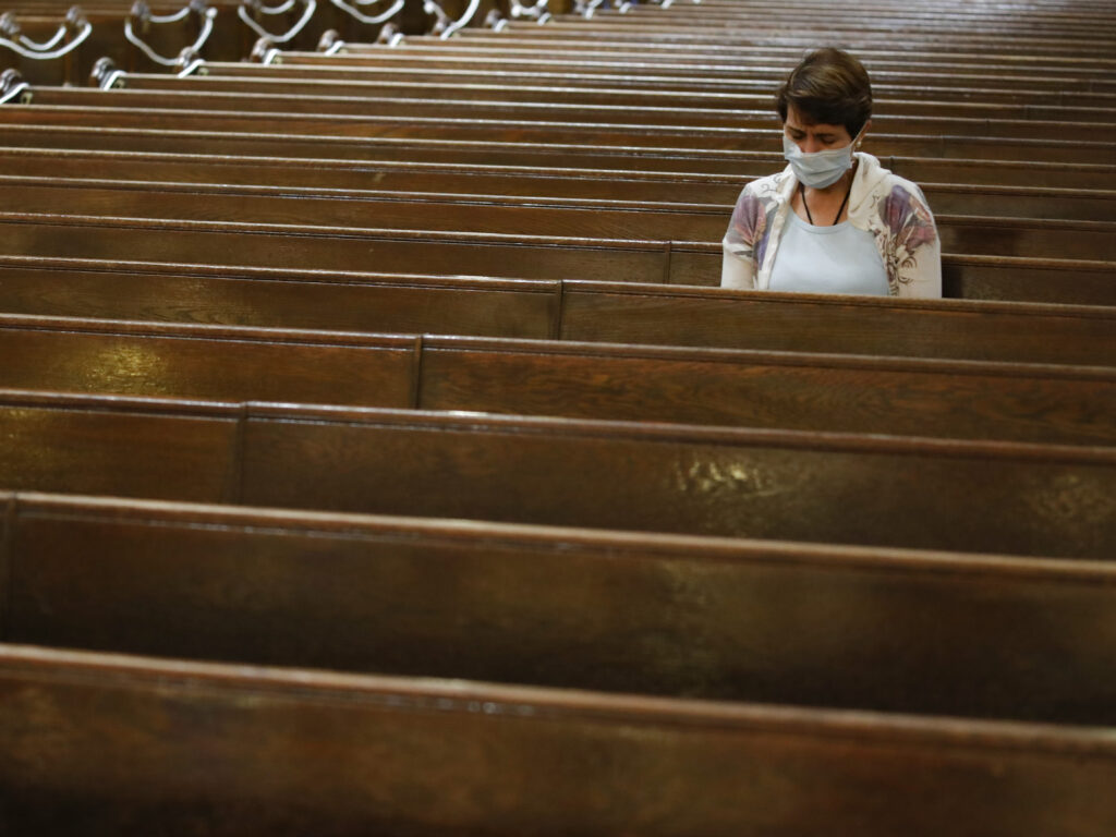 A parishioner sits after Mass last month at a Catholic church in New York City. An overwhelming majority of U.S. adults believe that houses of worship should be subject to the same restrictions on public gatherings that apply to other institutions. A parishioner sits after Mass last month at a Catholic church in New York City. An overwhelming majority of U.S. adults believe that houses of worship should be subject to the same restrictions on public gatherings that apply to other institutions. (John Minchillo/AP Photo)