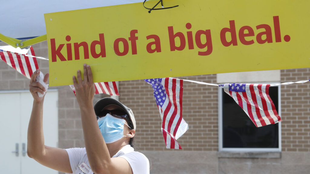 U.S. Census Bureau worker Marisela Gonzales adjusts a sign at a walk-up counting site for the 2020 census in Greenville, Texas, in July. U.S. Census Bureau worker Marisela Gonzales adjusts a sign at a walk-up counting site for the 2020 census in Greenville, Texas, in July. (LM Otero/AP Photo)