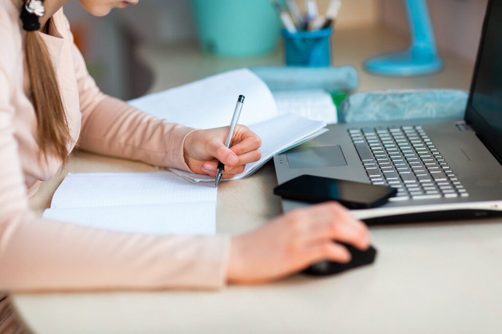 Close Up Of Young School Girl Left-handed Working At Home In Her (Len44ik/BigStock)