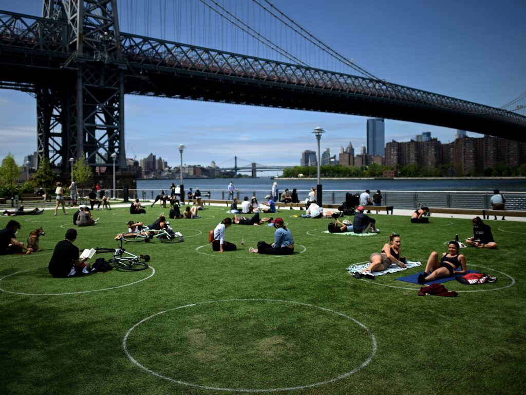 A new study has found that parks in low-income and majority nonwhite communities are smaller and serve a larger number of people per park acre. People are seen here relaxing in May in Brooklyn’s Domino Park. A new study has found that parks in low-income and majority nonwhite communities are smaller and serve a larger number of people per park acre. People are seen here relaxing in May in Brooklyn's Domino Park.
(Johannes Eisele/AFP via Getty Images)