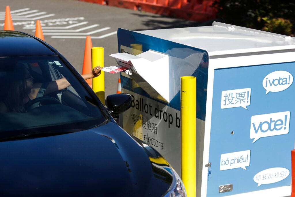 A voter inserts a ballot in a drive-up drop box last week in Renton, Wash., in that state’s primary. With more states expanding absentee voting due to the pandemic, the use of drop boxes is growing and leading to legal challenges from some Republicans. A voter inserts a ballot in a drive-up drop box last week in Renton, Wash., in that state's primary. With more states expanding absentee voting due to the pandemic, the use of drop boxes is growing and leading to legal challenges from some Republicans.