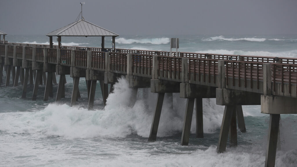 Waves crash along the Juno Beach Pier as Tropical Storm Isaias passes through the area Sunday in Juno Beach, Fla. The storm is now headed toward the Carolinas. Waves crash along the Juno Beach Pier as Tropical Storm Isaias passes through the area Sunday in Juno Beach, Fla. The storm is now headed toward the Carolinas.
