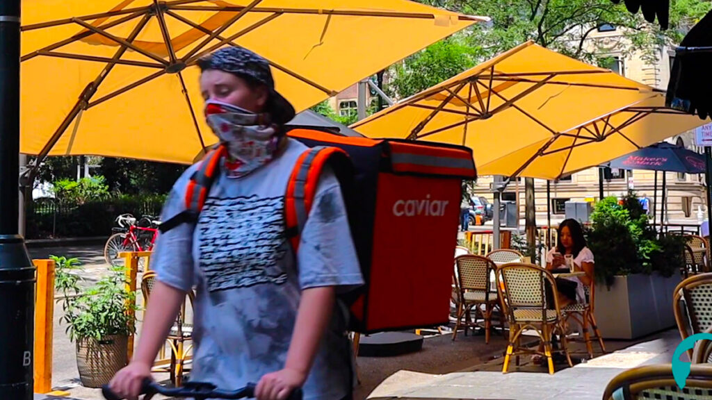 restaurant-workers-caviar-rittenhouse A food delivery courier passes an outdoor dining room in Philly's Rittenhouse neighborhood (Ashta Kunda/Billy Penn)