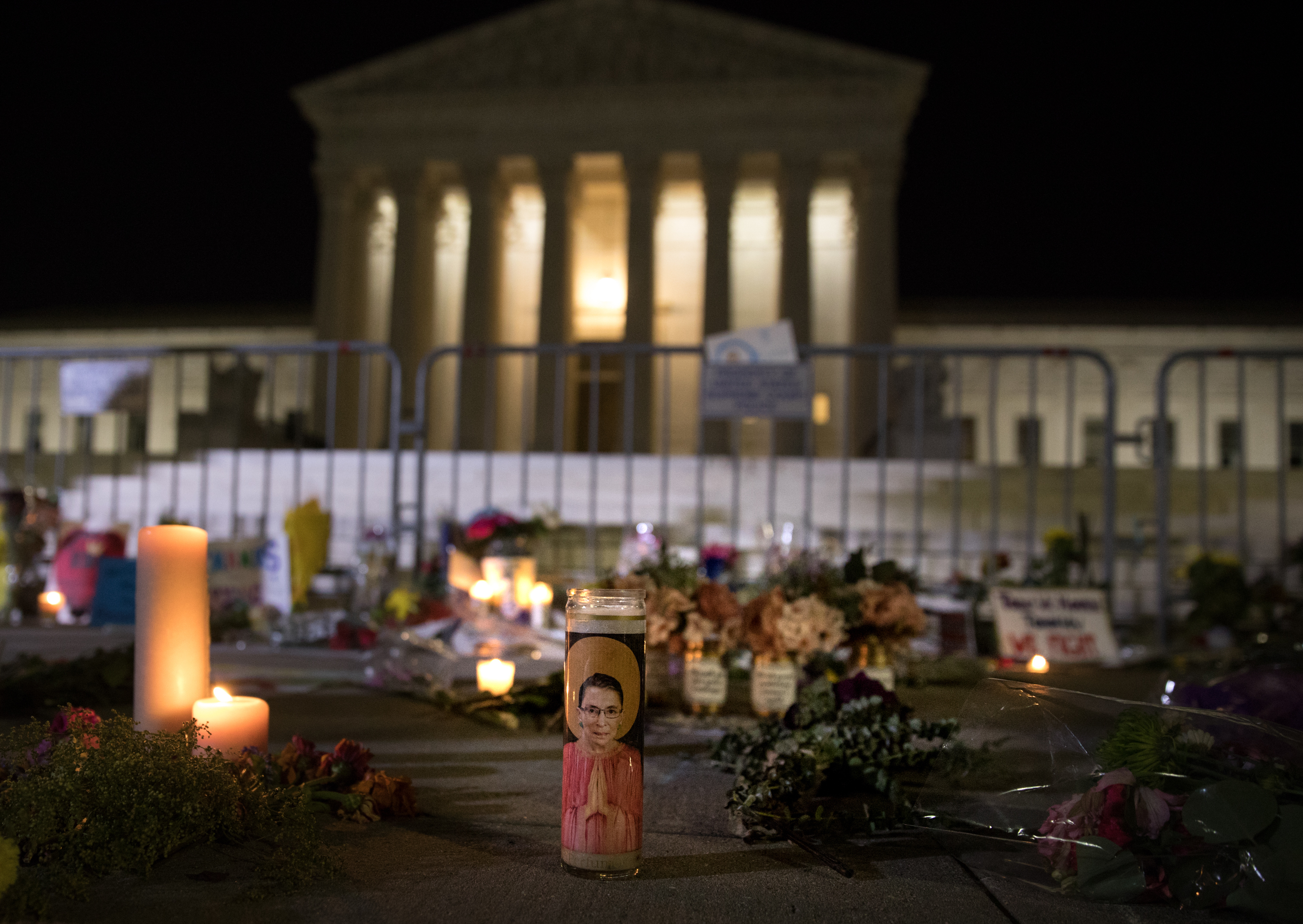 Mourners laid flowers and signs at the vigil.