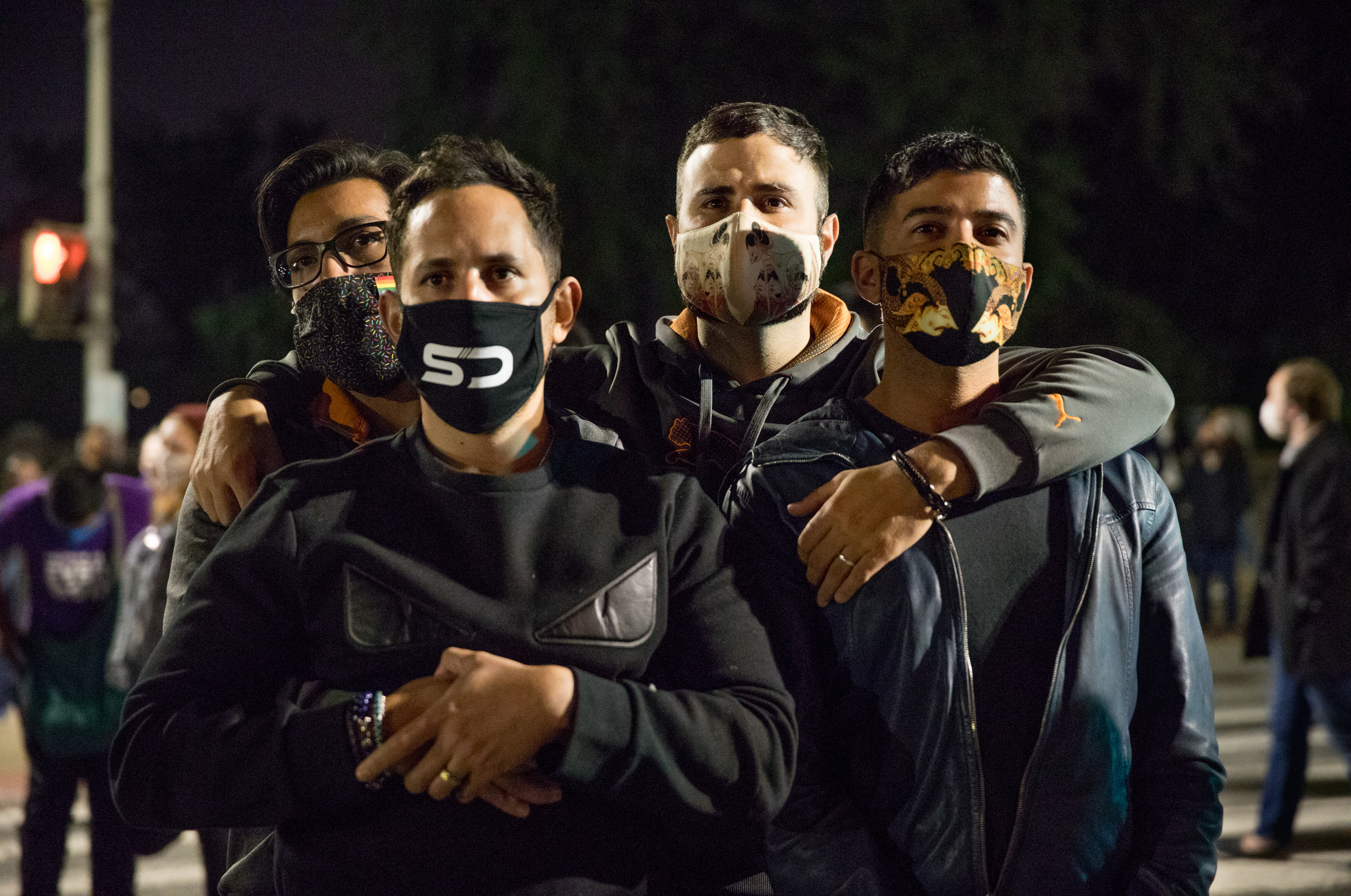 (Left to right) Kelvin Flores, Franklin Ortiz, Steven Zatarga and Shahab Albahar listen to speakers in front of the U.S. Supreme Court during the vigil.