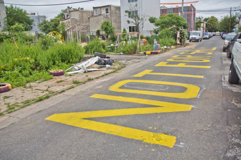 At the César Andreu Iglesias Community Garden in Kensington, the words “Not for sale” are painted on the street as a message to developers and the city. (Kimberly Paynter/WHYY)