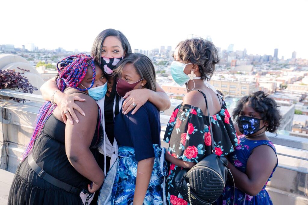 5f5110e756312.image Lady B embraces students after seeing her biography for the first time. (Sandrien B Photography)