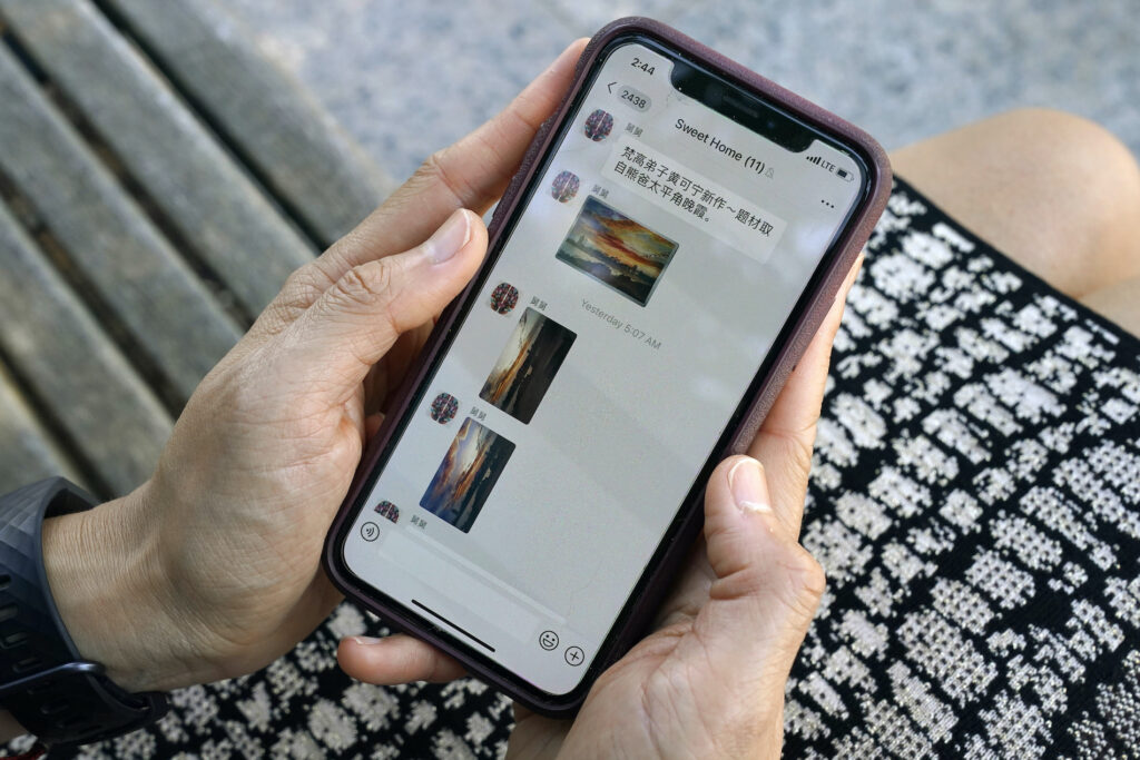 Sha Zhu Sha Zhu, of Washington, shows the app WeChat on her phone, which she uses to keep in touch with family and friends in the U.S. and China, Tuesday Aug. 18, 2020, in Washington. (AP Photo/Jacquelyn Martin)