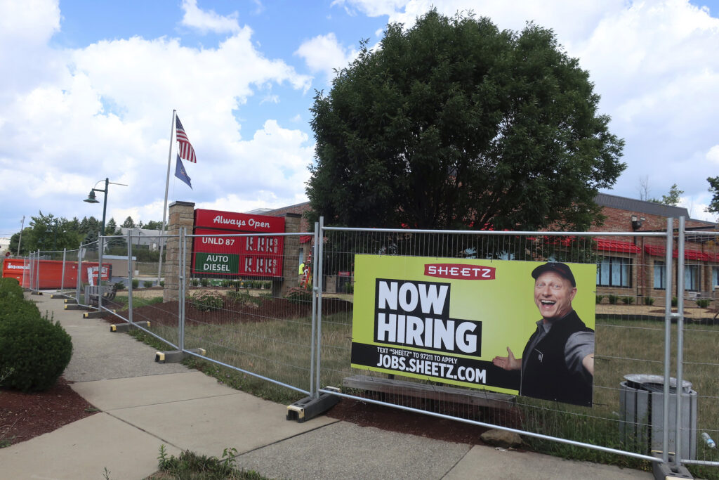 Economy Jobs A ‘Now Hiring’ sign hangs in front of a Sheetz convenience store and gas station under construction on Tuesday, August 18, 2020 in Wexford, Pennsylvania. (AP Photo/Ted Shaffrey)