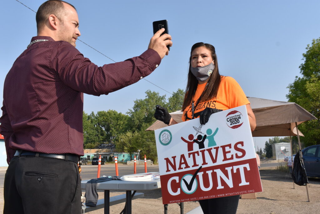 Virus Outbreak-Census-Tribes Activist Lauri Dawn Kindness, right, speaks at the Crow Indian Reservation, in Lodge Grass, Mont. on Wednesday, Aug. 26, 2020, as Lodge Grass Mayor Quincy Dabney records her for a social media campaign to increase Native American participation in the U.S. census. (AP Photo/Matthew Brown)