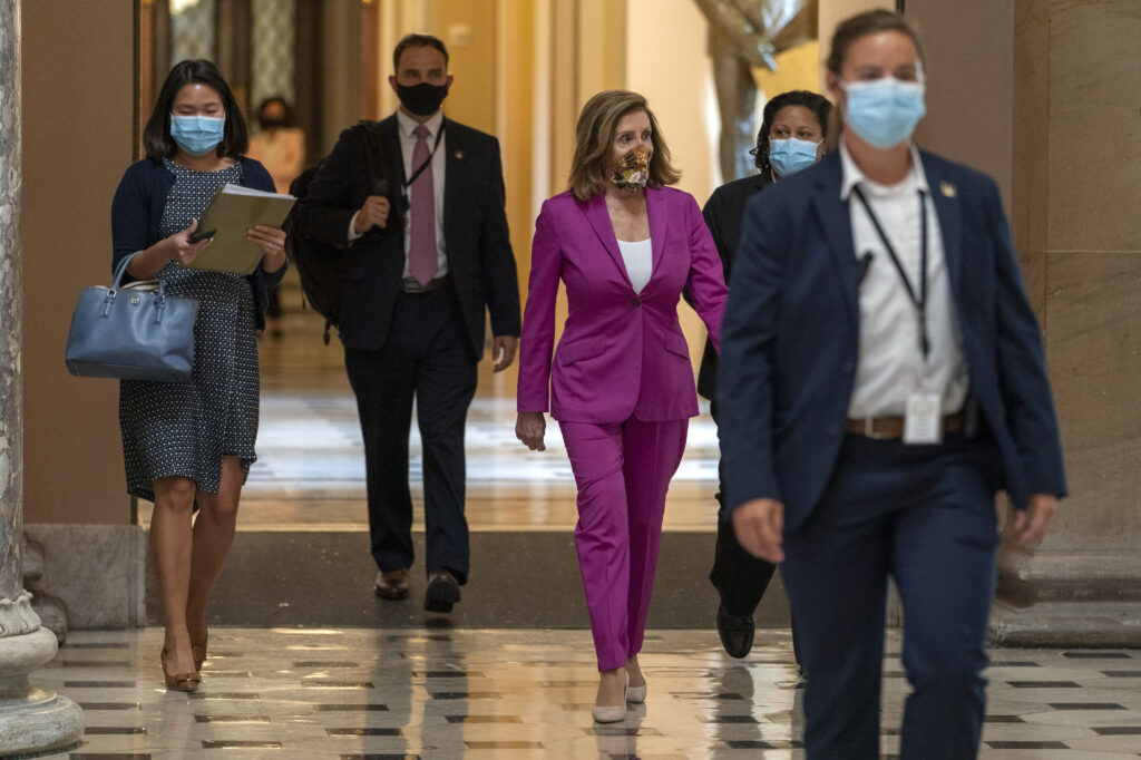 Nancy Pelosi House Speaker Nancy Pelosi of Calif., center, walks to her office, Monday, Sept. 14, 2020, on Capitol Hill in Washington. (AP Photo/Jacquelyn Martin)