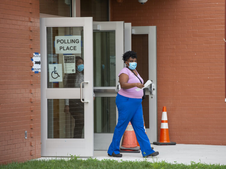 A person walks out of a polling station
