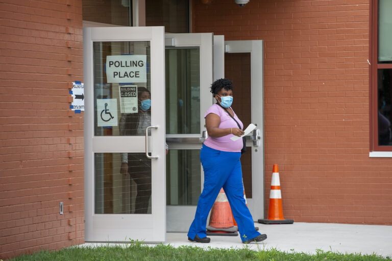 A person walks out of a polling station