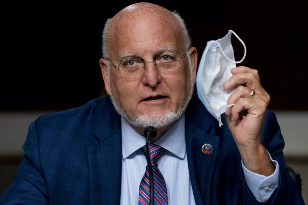 Virus Outbreak Congress Centers for Disease Control and Prevention Director Dr. Robert Redfield holds up his mask as he speaks at a Senate Appropriations subcommittee hearing on a “Review of Coronavirus Response Efforts” on Capitol Hill, Wednesday, Sept. 16, 2020, in Washington. (AP Photo/Andrew Harnik)