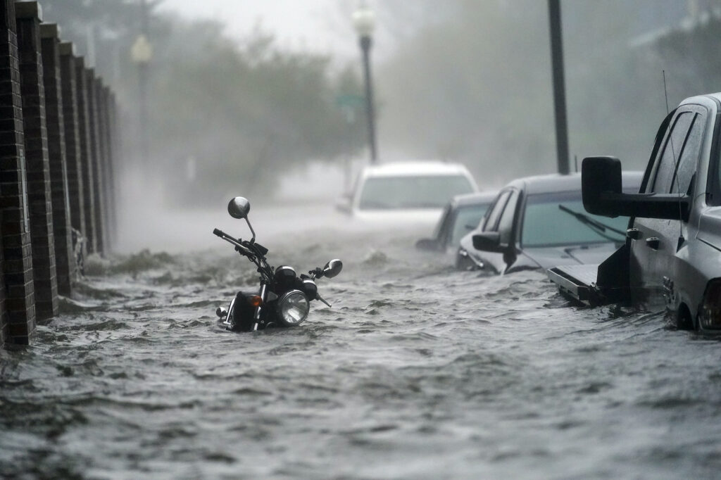 APTOPIX Tropical Weather Floodwaters move on the street, Wednesday, Sept. 16, 2020, in Pensacola, Fla. Hurricane Sally made landfall Wednesday near Gulf Shores, Alabama, as a Category 2 storm, pushing a surge of ocean water onto the coast and dumping torrential rain that forecasters said would cause dangerous flooding from the Florida Panhandle to Mississippi and well inland in the days ahead.(AP Photo/Gerald Herbert)