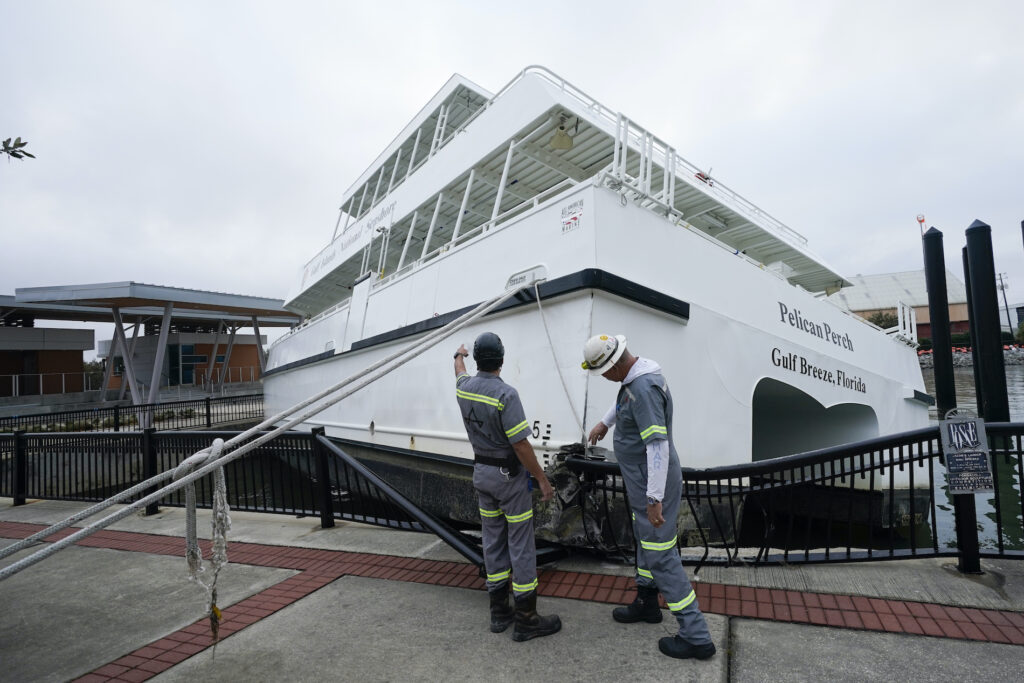 Tropical Weather Workers look over a damaged ferry, Thursday, Sept. 17, 2020, in Pensacola, Fla. (AP Photo/Gerald Herbert)