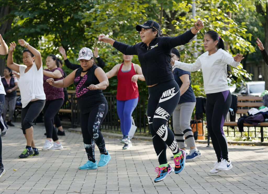 Earns Nike Yeni Salazar, center, leads a Zumba class in Queen's Elmhurst Memorial Park, Monday, Sept. 21, 2020 in New York. Salazar has been leading the morning outdoor classes since May because the COVID-19 pandemic has closed her health club. (AP Photo/Mark Lennihan)