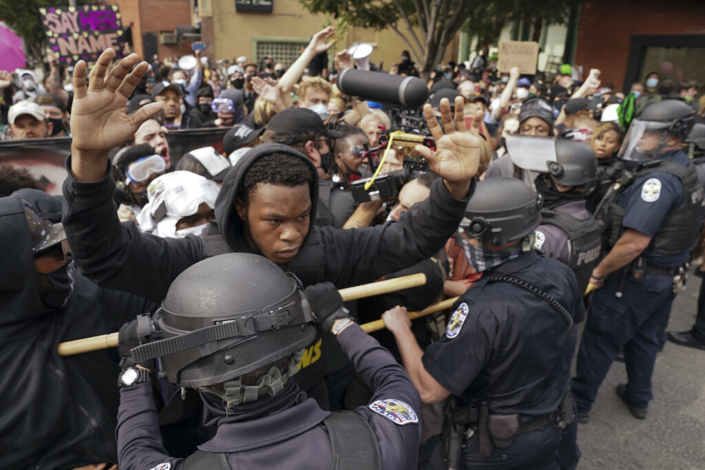 APTOPIX Racial Injustice Breonna Taylor Police and protesters converge during a demonstration, Wednesday, Sept. 23, 2020, in Louisville, Ky. A grand jury has indicted one officer on criminal charges six months after Breonna Taylor was fatally shot by police in Kentucky. The jury presented its decision against fired officer Brett Hankison Wednesday to a judge in Louisville, where the shooting took place. (AP Photo/John Minchillo)