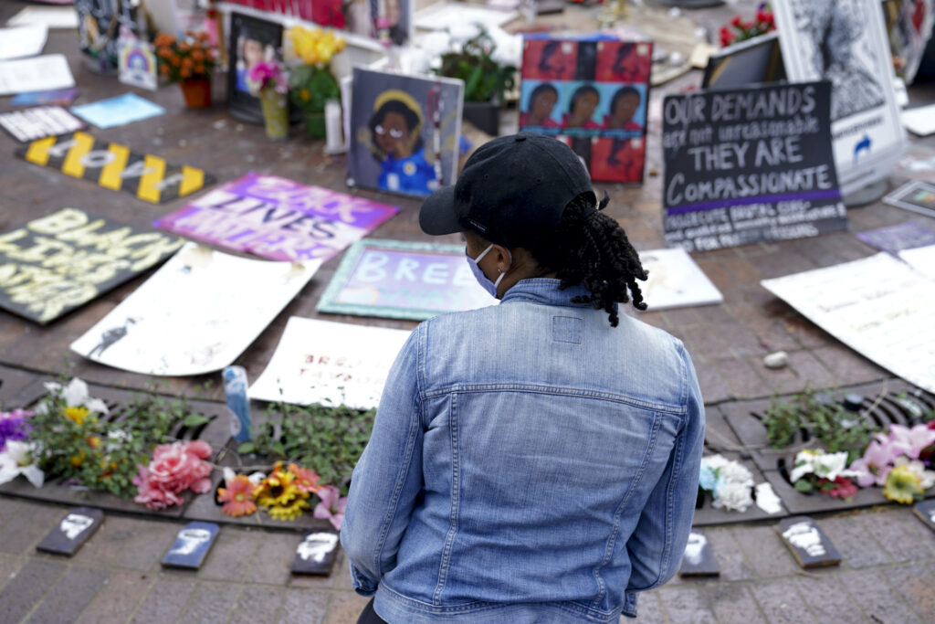 Millicent Cahoon stands for a portrait, Thursday, Sept. 24, 2020, in Louisville, Ky. “It’s reiterating to me that my life does not matter, that I’m unsafe,” said Millicent Cahoon, a therapist who started a counseling network for the protest movement. (AP Photo/John Minchillo)