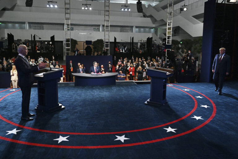 Democratic presidential candidate former Vice President Joe Biden gestures as President Donald Trump walks onto stage for the first presidential debate Tuesday, Sept. 29, 2020, at Case Western University and Cleveland Clinic, in Cleveland. (Olivier Douliery/Pool via AP)
