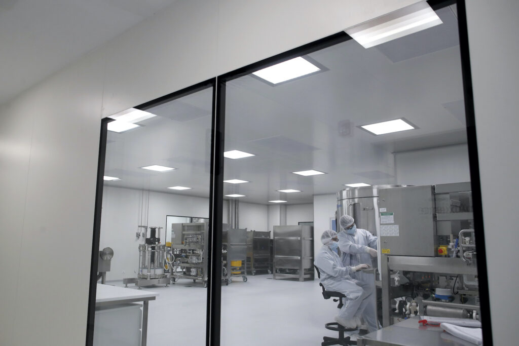 Laboratory technicians work at the mAbxience biopharmaceutical company in Garin, Argentina, Friday, Aug. 14, 2020. Under an agreement between Argentina and Mexico announced this week, the company is going to make an experimental coronavirus vaccine developed by Oxford University and the laboratory AstraZeneca, and if approved the vaccine will be distributed in Latin America. (AP Photo/Natacha Pisarenko)