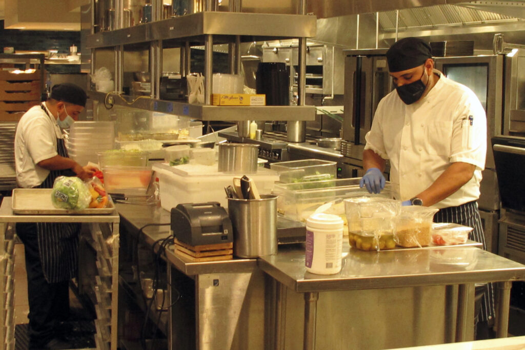 Virus Outbreak-Indoor Dining-NJ Kitchen workers prepare food in a restaurant inside the Hard Rock casino in Atlantic City N.J. on Sept. 1, 2020. (AP Photo/Wayne Parry)