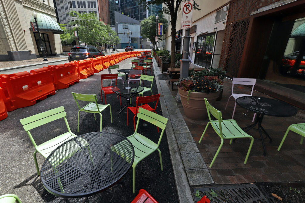 Outdoor dining in Pennsylvania Orange barriers enclose chairs and tables that will be used for dining along Sixth Street between Liberty and Penn avenues