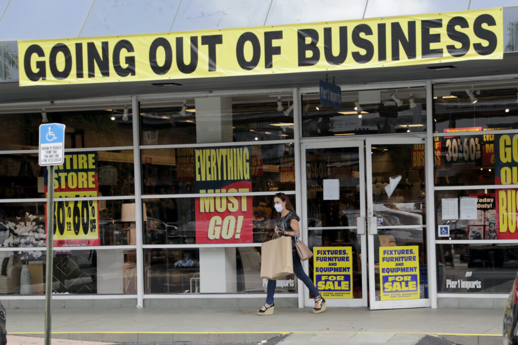 Virus Outbreak Unemployment Benefits A customer leaves a Pier 1 retail store, which is going out of business