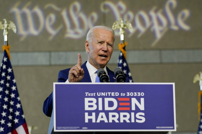 Joe Biden speaks from a podium as 