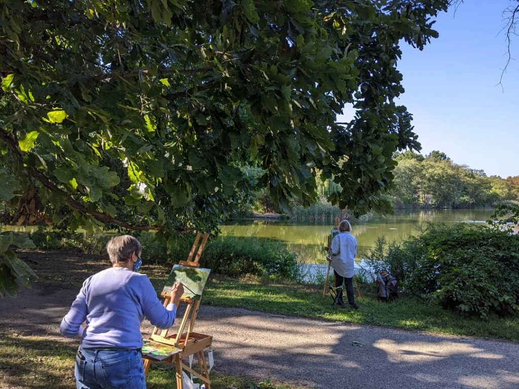 FDR PARK Two woman paint overlooking the lake at FDR Park. (Courtesy Friends of FDR Park)