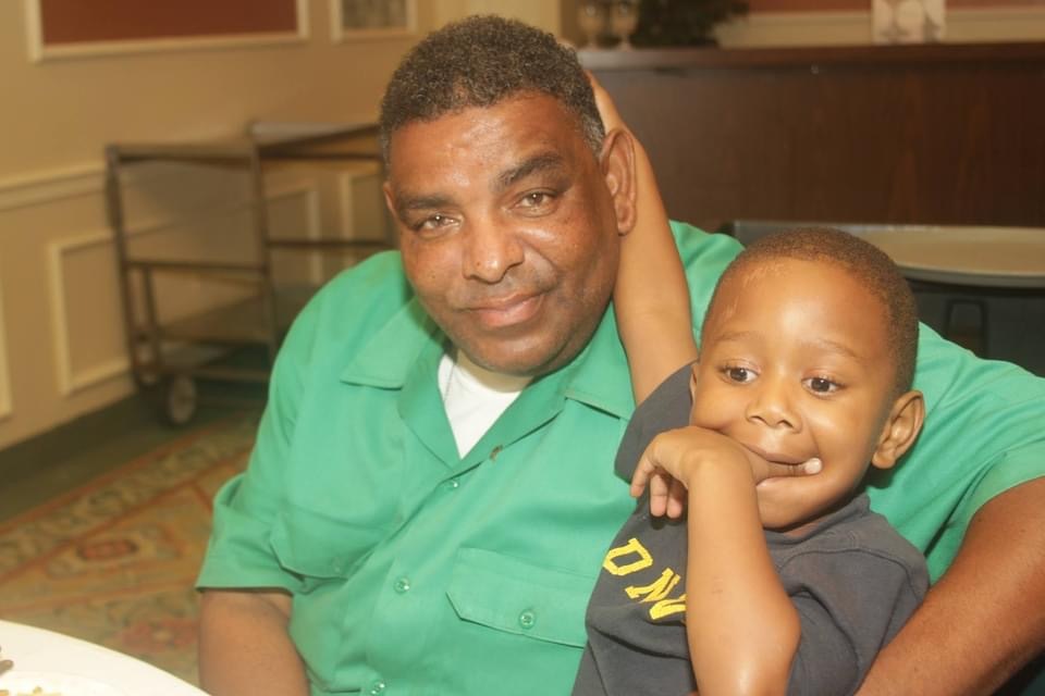 IMG_0334 Malik Aziz with his grandson. (Photo courtesy of Aziz family)
