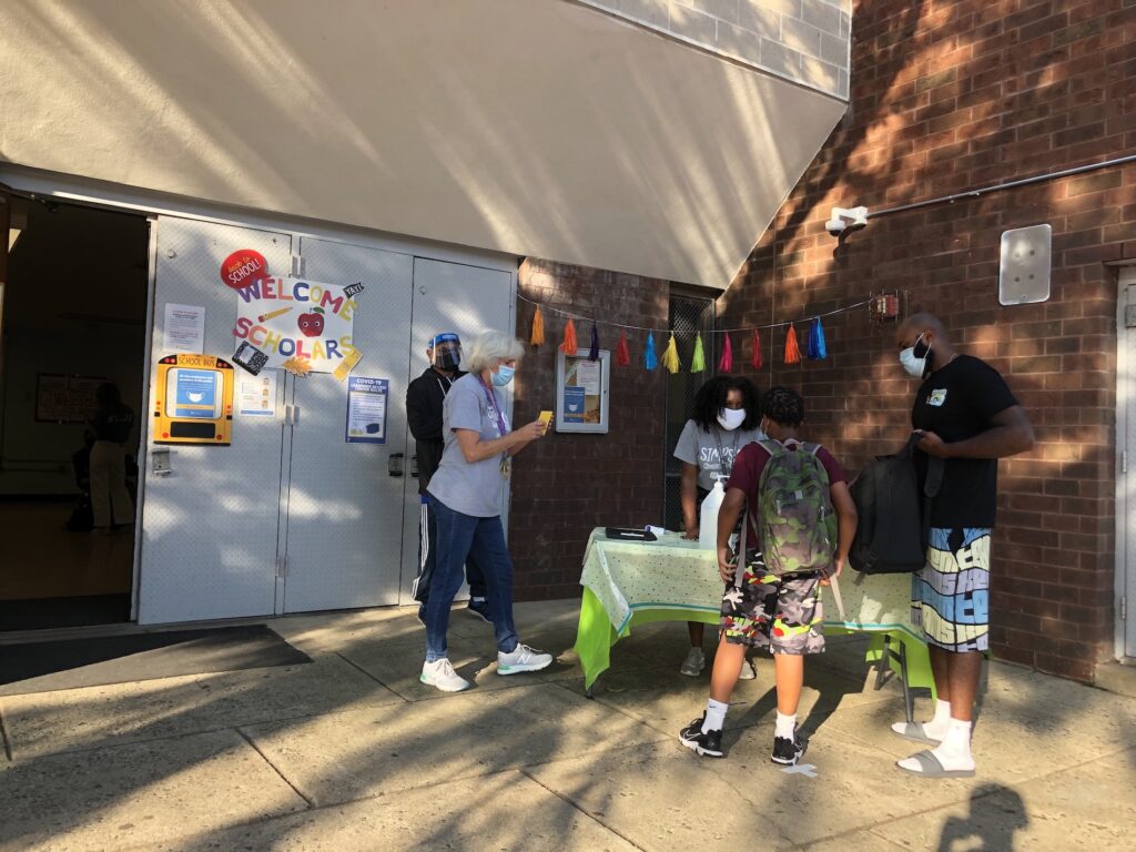 IMG_6432 Tammy Harrity and other Simpson Recreation Center staffers greet Kyree Robinson and his son Syire. (Emily Rizzo for WHYY)