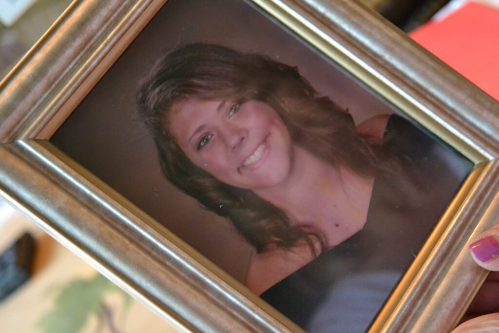 Kim-photo-1920×1280 In this June 2019 photo, Martha Stringer holds a photo of her daughter, Kim. (Brett Sholtis / Transforming Health)