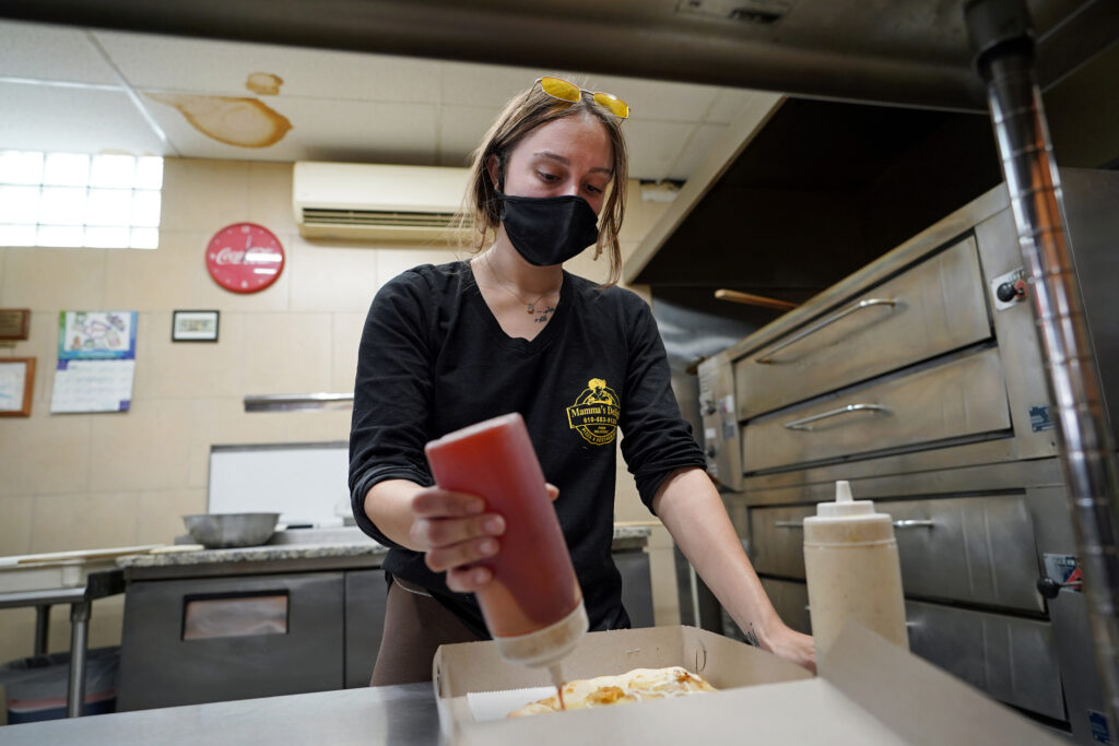Kutztown deals with a spike in COVID-19 cases as Kutztown University welcomes students back to campus Jessica Symes, a senior at Kutztown University, works on a pizza order at Mamma's Delight Pizza Restaurant in Kutztown, Pennsylvania. (Matt Smith for Keystone Crossroads)
