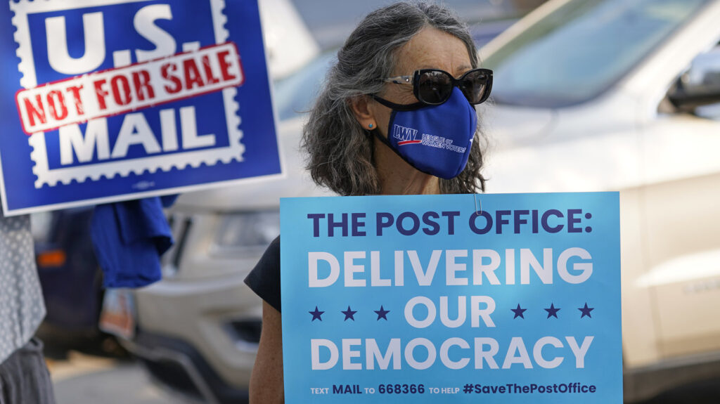 Irene Huber joins others during a “Save the Post Office” rally Irene Huber joins others during a