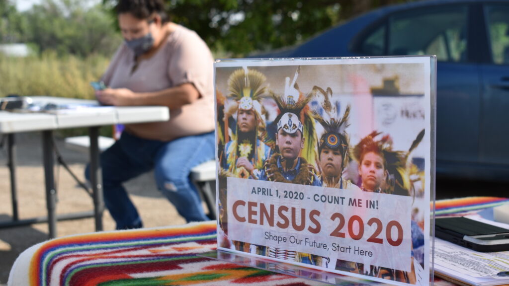 A sign promoting participation in the 2020 census is displayed as Selena Rides Horse enters information into a phone for a member of the Crow Indian Tribe in Lodge Grass, Mont. in August. A sign promoting participation in the 2020 census is displayed as Selena Rides Horse enters information into a phone for a member of the Crow Indian Tribe in Lodge Grass, Mont. in August. (Matthew Brown/AP Photo)