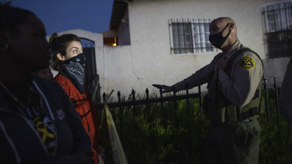 A protester talks with a deputy of the Los Angeles Sheriff’s Department during demonstrations following the death of a Black man identified as Dijon Kizzee on Monday in Los Angeles. A protester talks with a deputy of the Los Angeles Sheriff's Department during demonstrations following the death of a Black man identified as Dijon Kizzee on Monday in Los Angeles. (Christian Monterrosa/AP)