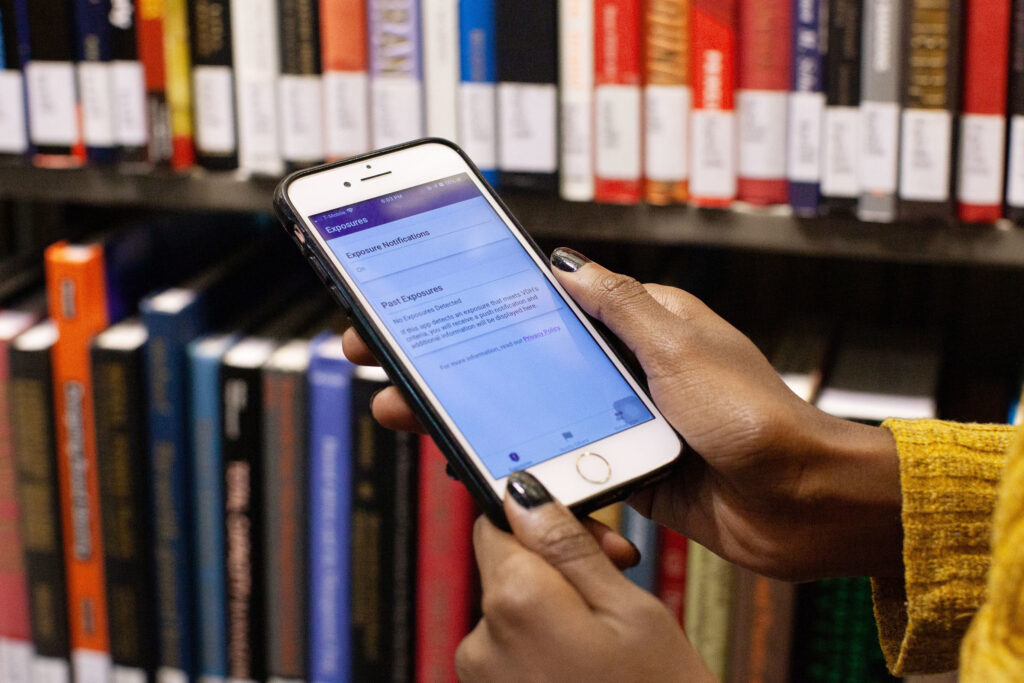 Mohamed checks the COVIDWISE app on her smartphone to detect if she has been exposed to the coronavirus. Mohamed checks the COVIDWISE app on her phone
