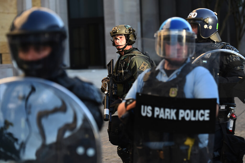 U.S. Park Police and other federal officers hold a perimeter near the White House on June 1 as demonstrators gather to protest the killing of George Floyd. U.S. Park Police and other federal officers hold a perimeter near the White House on June 1 as demonstrators gather to protest the killing of George Floyd.
Olivier Douliery/AFP via Getty Images