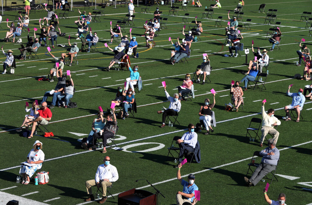 The annual town meeting in North Andover, Mass., which dates back to 1646, was held outside on June 16 on a high school football field to help keep participants a safe distance from each other. The annual town meeting in North Andover, Mass., which dates back to 1646, was held outside on June 16 on a high school football field to help keep participants a safe distance from each other.
(Jim Davis/The Boston Globe via Getty Images)