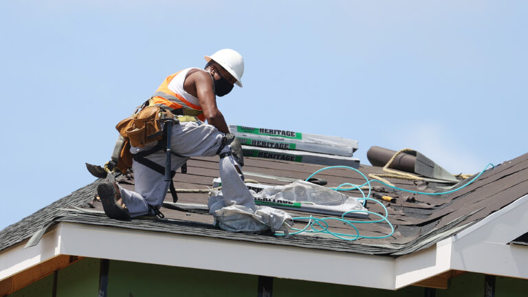 A construction worker roofs an apartment complex in Uniondale, N.Y., on May 27. U.S. employers added fewer jobs last month even as the unemployment rate fell to 8.4%. (Al Bello/Getty Images)