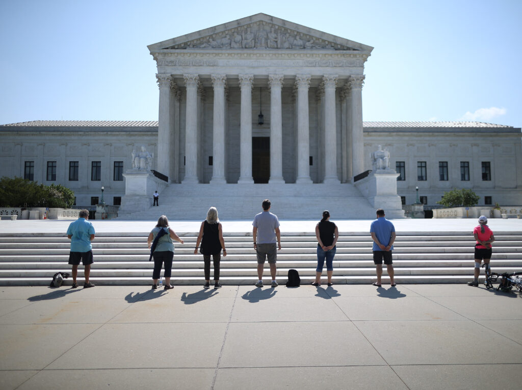 Anti-abortion demonstrators pray in front of the U.S. Supreme Court July 8, a day the court ruled that employers with religious objections can decline to provide contraception coverage under the Affordable Care Act. With the death of Ruth Bader Ginsburg, the ACA’s future is in doubt. Anti-abortion demonstrators pray in front of the U.S. Supreme Court July 8, a day the court ruled that employers with religious objections can decline to provide contraception coverage under the Affordable Care Act. With the death of Ruth Bader Ginsburg, the ACA's future is in doubt.