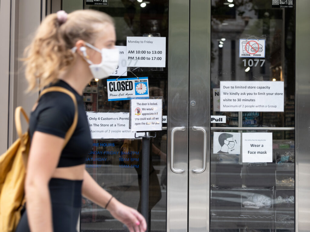 New coronavirus infections are on the rise in the U.S., with cases surpassing 7 million this week. Some two dozen states reported increases in new infections, with a handful of states marking new daily records. A person walking wearing a face mask