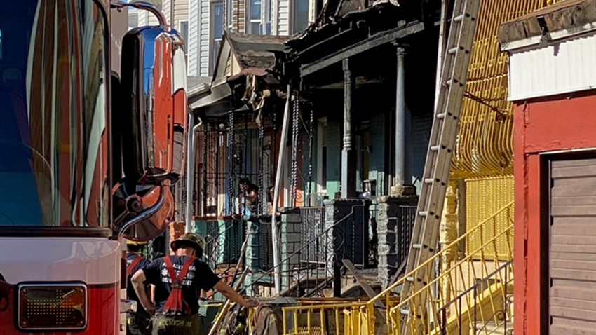 kensington-house-fire-09052020 A Philadelphia firefighter stands in front of a charred rowhouse after a deadly blaze in Kensington. (NBC10)