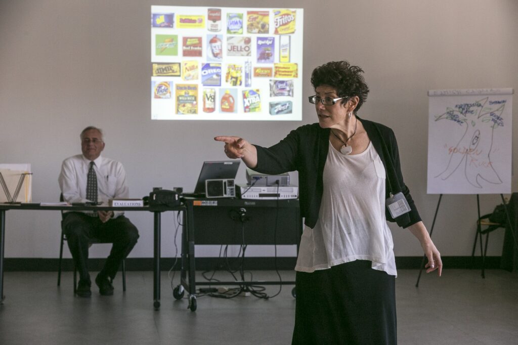 main AP233147156532 In this Feb. 11, 2015, photo, veteran LAPD officers Don Wynne, left, and Ann Bozzi instruct dozens of unidentified Los Angeles Police Department officers learn to recognize unconscious prejudices and how they can impact behaviors on the street at a class at the Museum of Tolerance in Los Angeles. The department, which expects to send more than 5,000 officers to the museum’s course in the next several years, is working to weave implicit bias lessons into existing training. (AP Photo/Damian Dovarganes)