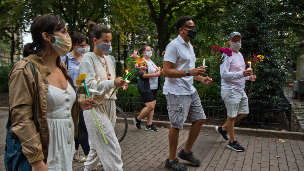 Friends of Sarah Pitt lit candles and carried flowers at Rittenhouse Square park in Philadelphia for a vigil and a march in her honor. (Kimberly Paynter/WHYY)